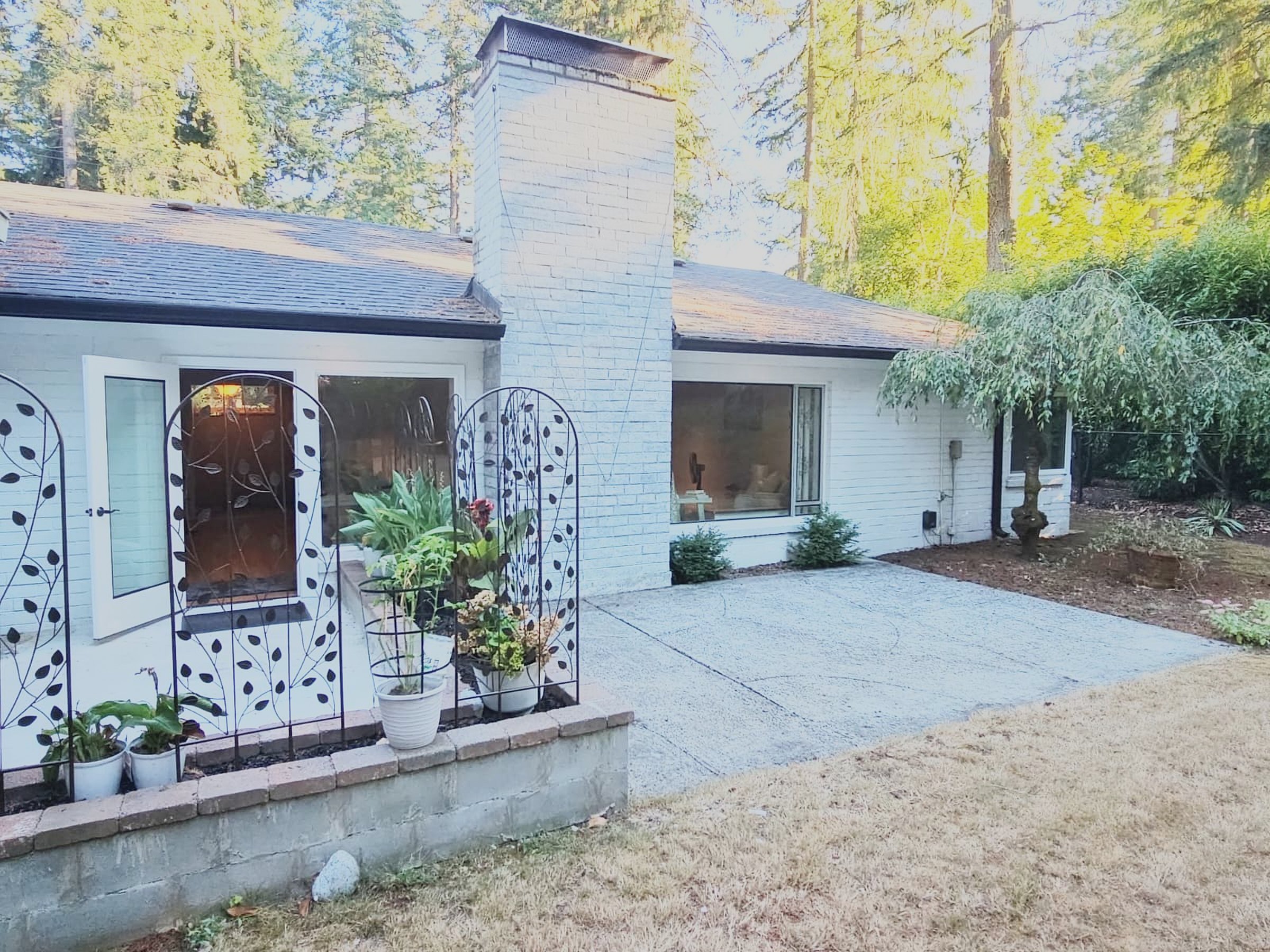 Garden patio with planters and decorative trellises